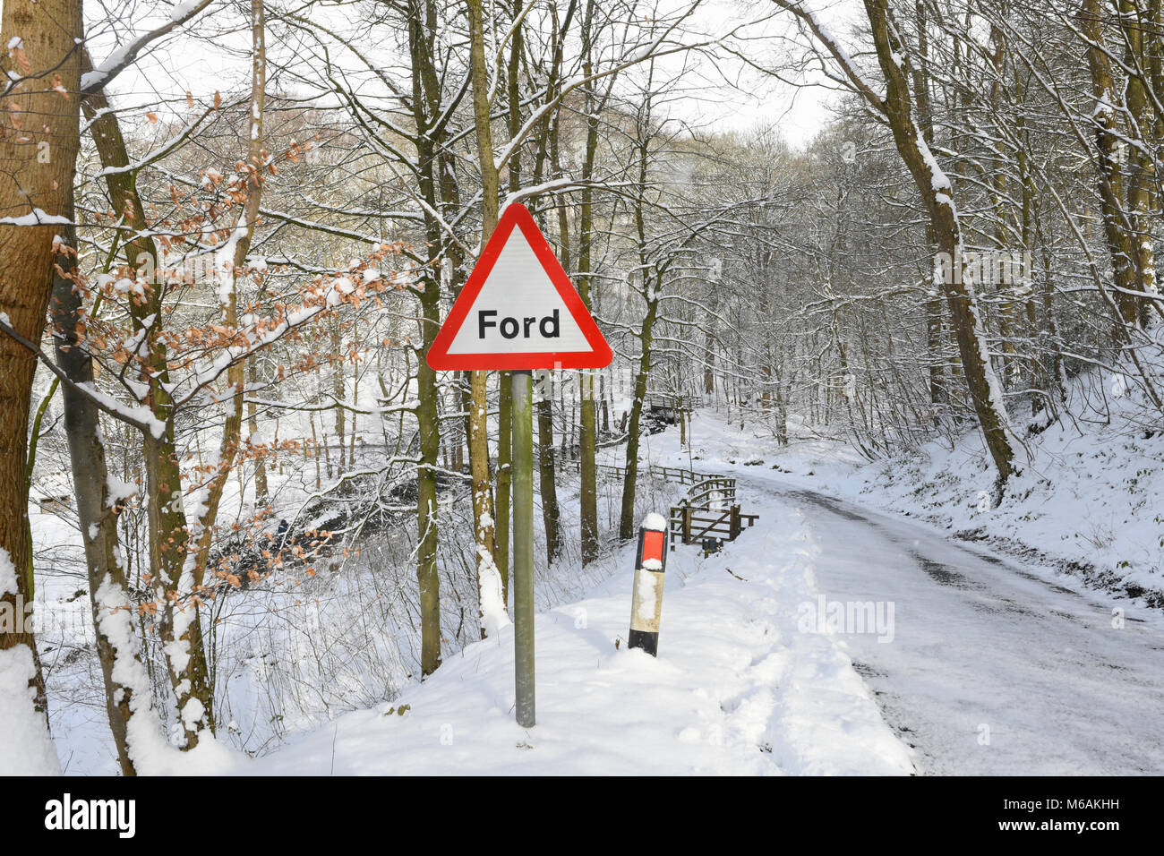 ford warning sign by river wharfe flowing through winter landscape at bolton abbey wharfedale yorkshire dales united kingdom Stock Photo
