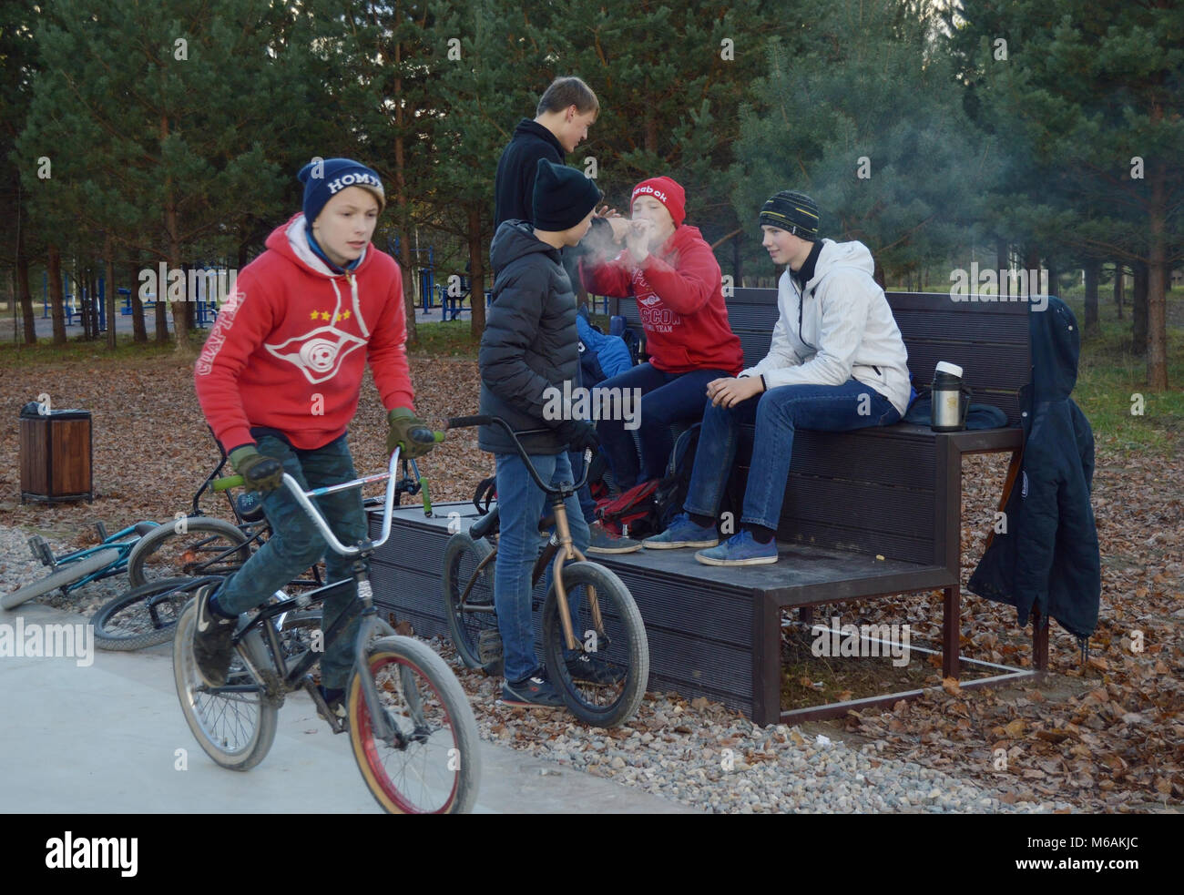 Dobrograd, Vladimir region, Russia. 23 October 2016. Teens with BMX bikes  with vape resting in the skatepark Stock Photo