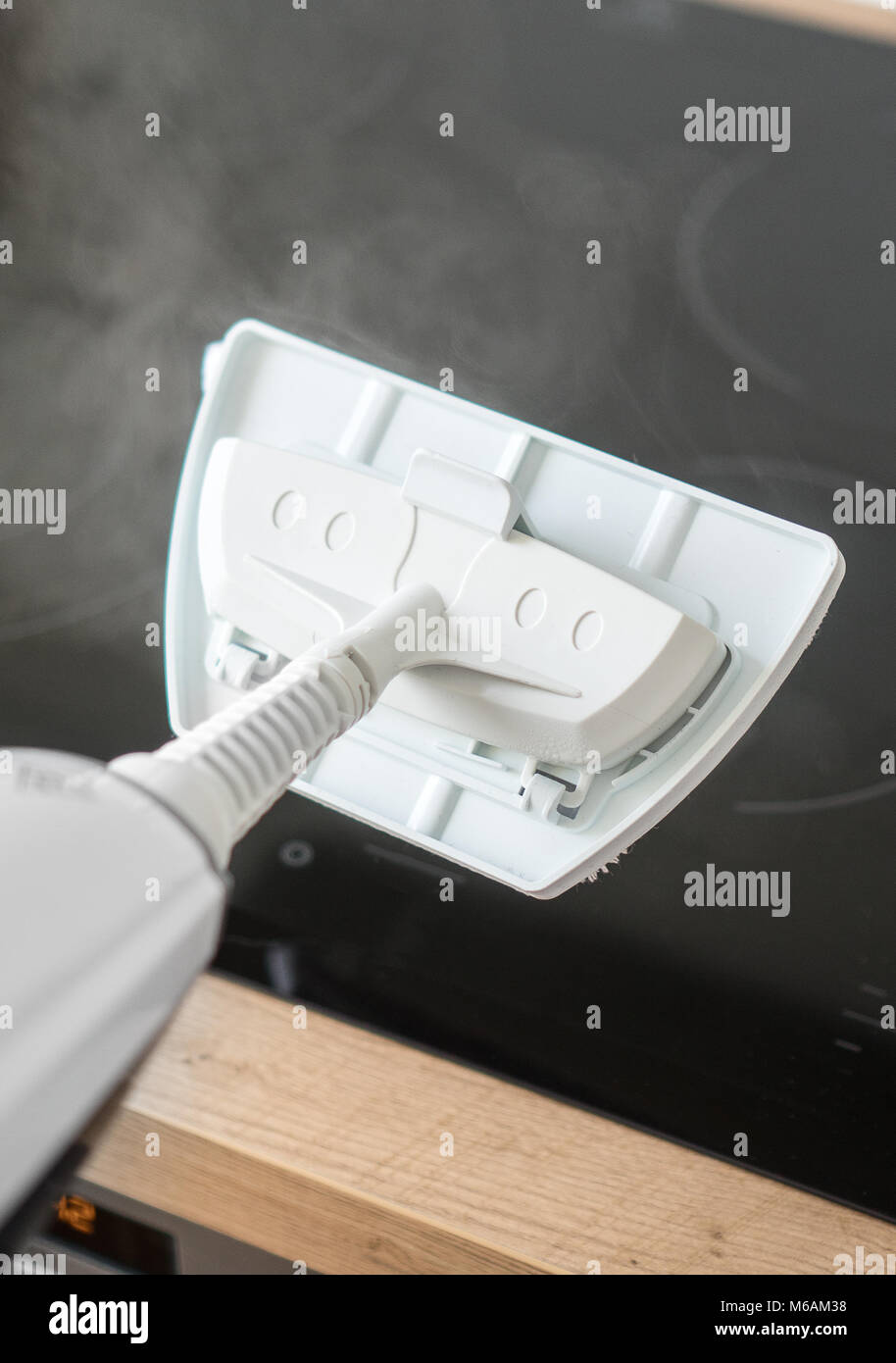 Cleaning kitchen hob with a steam cleaner Stock Photo Alamy