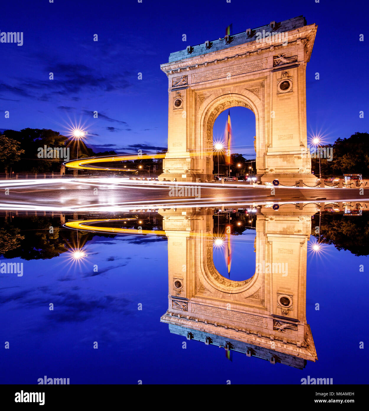 Bucharest, Romania. Arc de triomphe. Night panoramic view. Artistic interpretation, mirror effect. Stock Photo