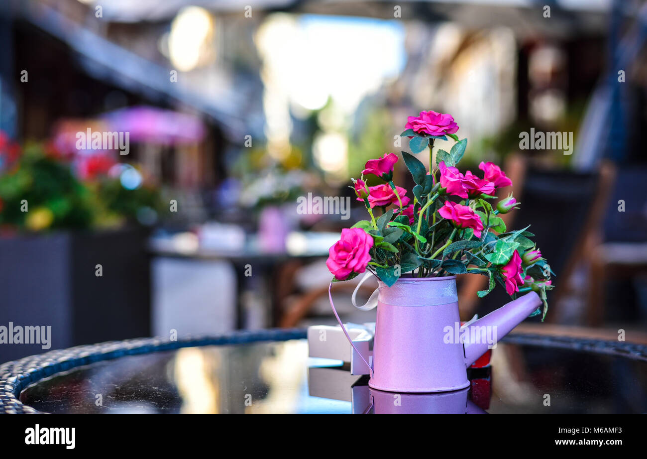 Table flowers at restaurant, outside terrace in the old city center of Bucharest Stock Photo