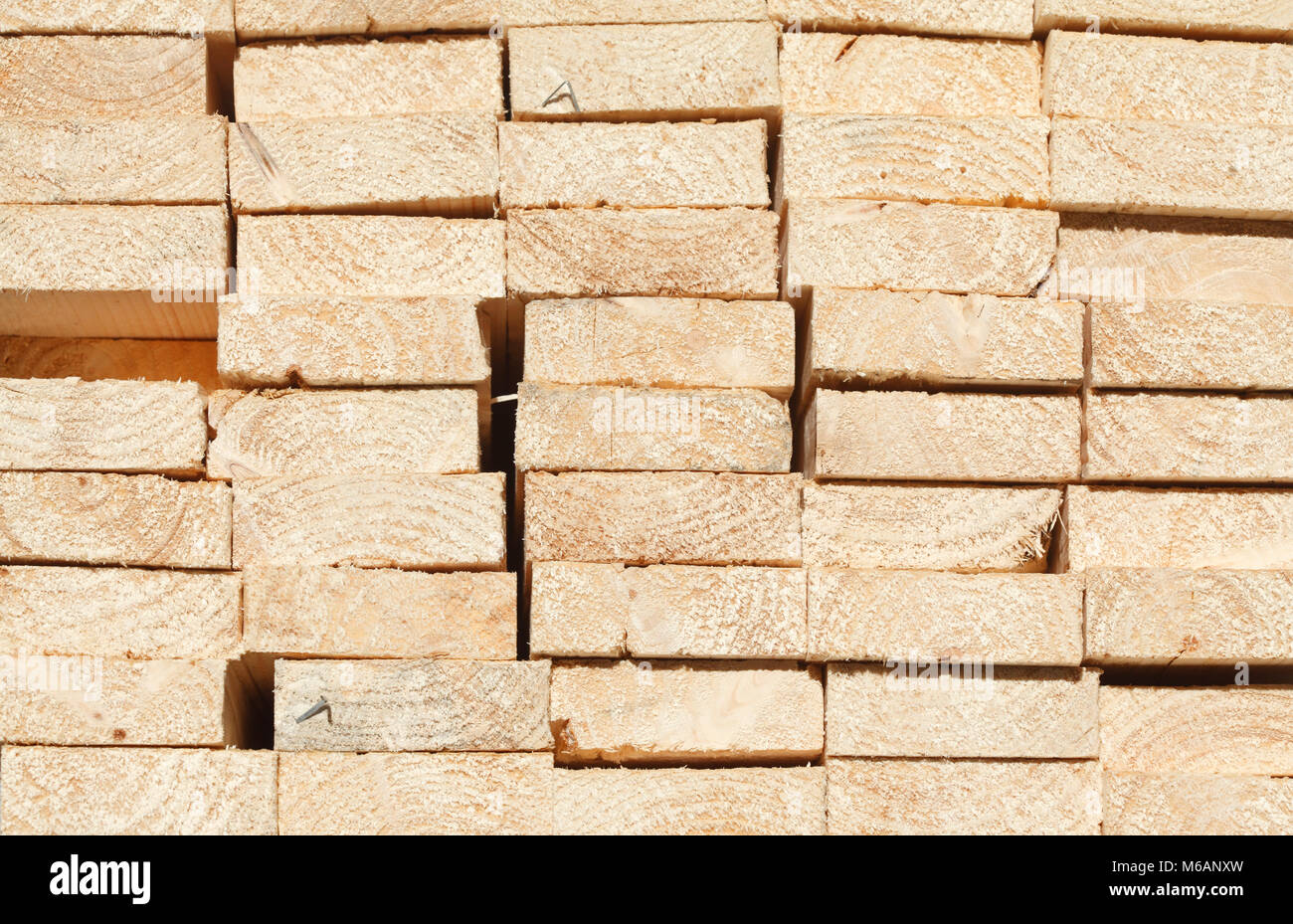 stacked up wooden boards on a construction site Stock Photo