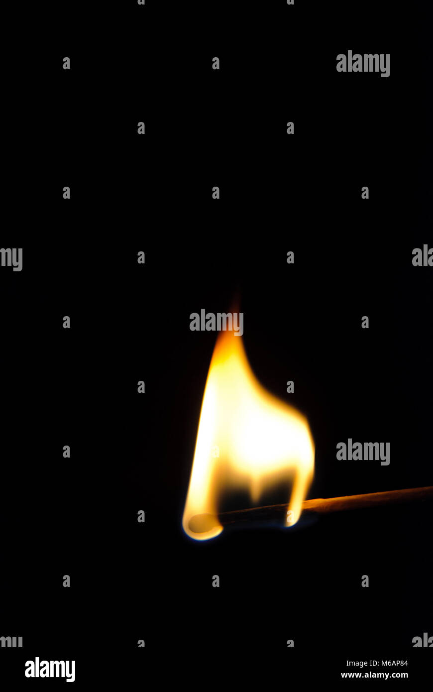 Burning match on black background Stock Photo - Alamy