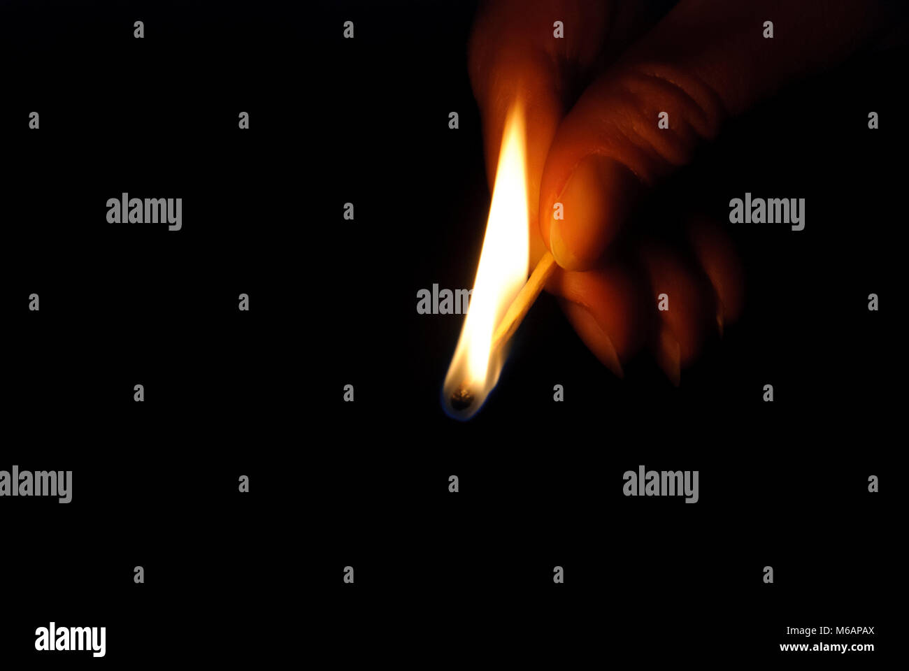 Burning match on black background Stock Photo - Alamy