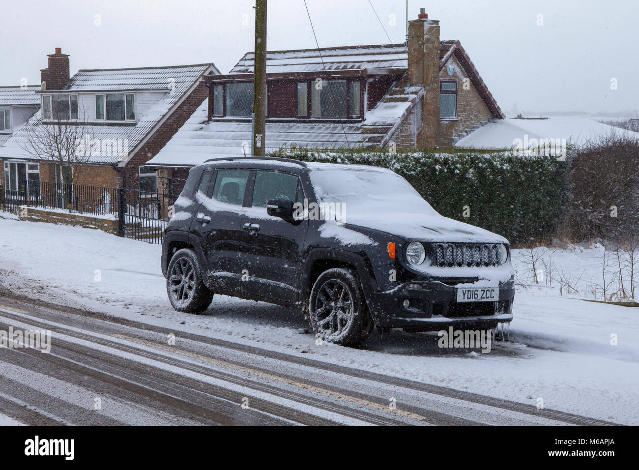 The freezing Arctic weather nicknamed the Beast from the East bringing snow and bad weather to Leeds freezing up a Jeep Renegade SUV Stock Photo