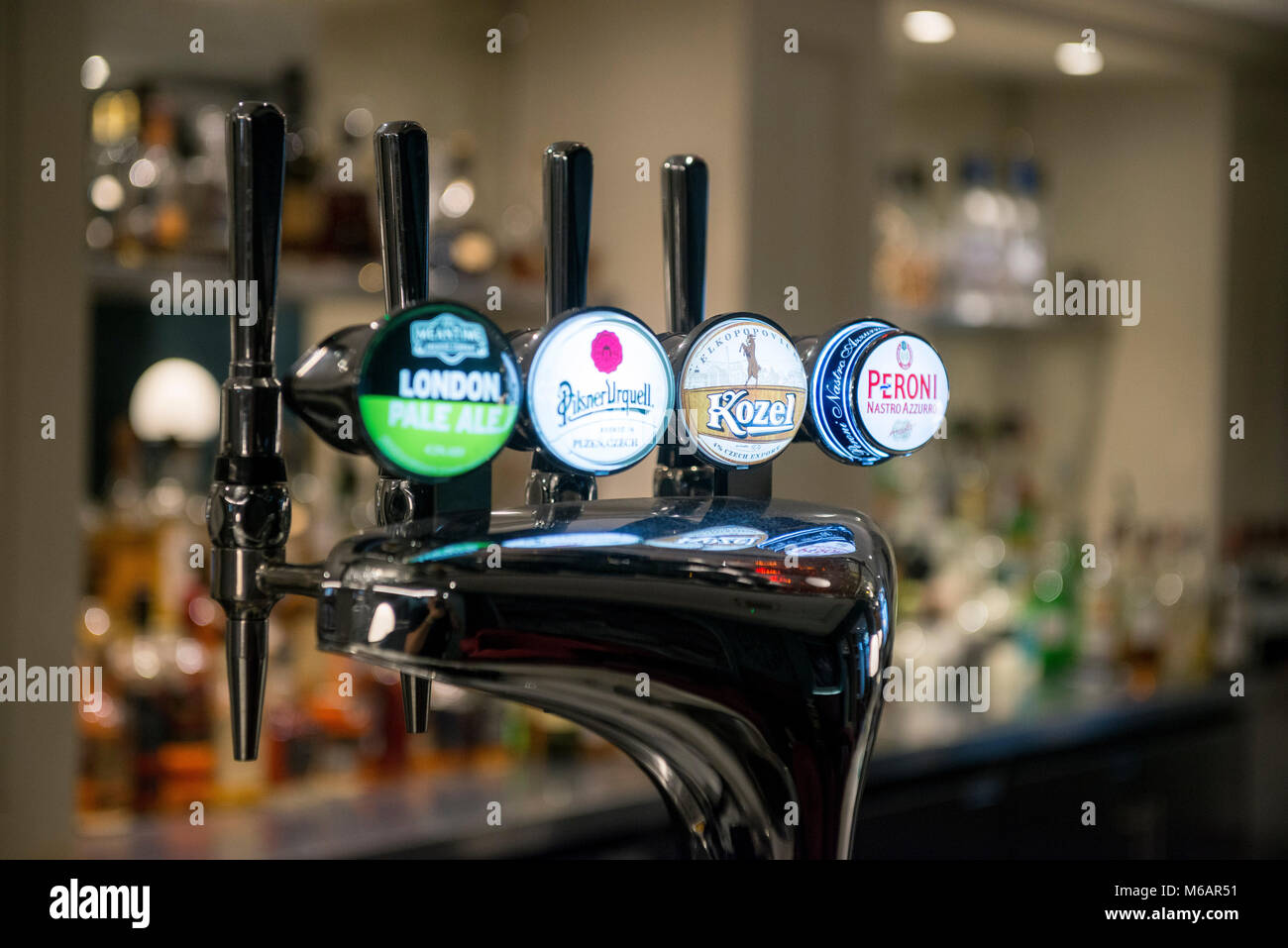 a backbar display and beer pumps with drinks on tap at a hotel bar