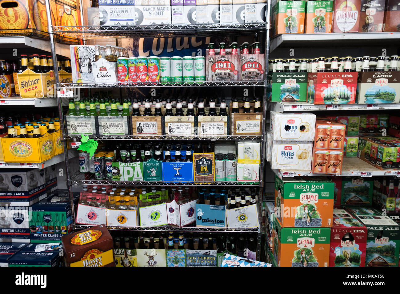 A walk in cooler, or beer cave, in a grocery store in Speculator, NY USA full of different brands of beer and ale. Stock Photo