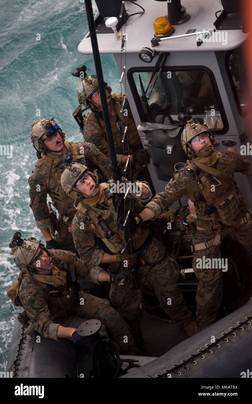 Force Reconnaissance Marines with Maritime Raid Force, 31st Marine Expeditionary Unit, hook a caving ladder in Guam, January 26, 2018, during Visit Board Search and Seizure training. VBSS teaches Marines how to take over ships for searches and counter-piracy operations.  As the Marine Corps' only continuously forward-deployed MEU, the 31st MEU provides a flexible force ready to perform a wide range of military operations. (U.S. Marine Corps Stock Photo