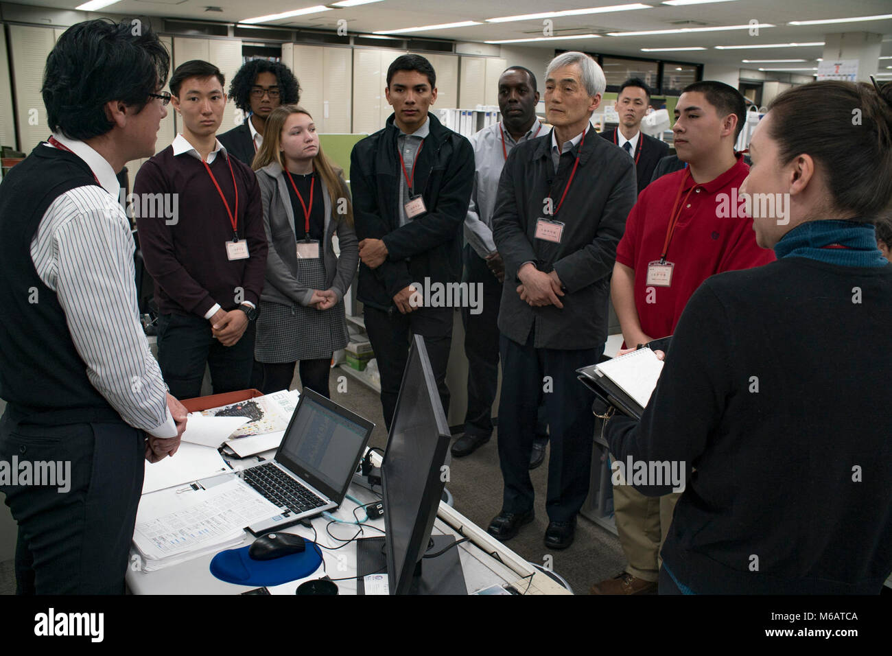 Seiji Fujimoto, a first-class architect and supervisor for the architectural department with Chuden Engineering Consultants (CEC), talks to American visitors from Marine Corps Air Station Iwakuni, Japan, at the CEC’s facility in Hiroshima, Feb. 8, 2018. The Defense Policy Review Initiative (DPRI) scheduled a day with CEC to host their first American visitors, which included five Matthew C. Perry High School students, DPRI employees and a Matthew C. Perry teacher, for a tour of the building and to visit with their employees to see how they work. (U.S. Marine Corps Stock Photo