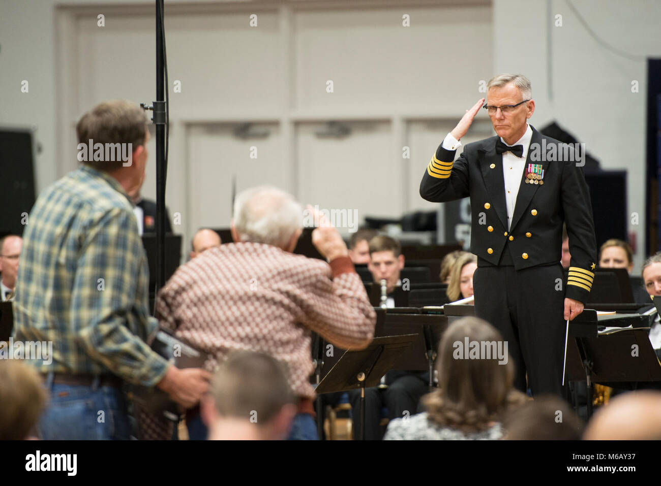 PRICE, Utah (Feb. 27, 2018) Commanding Officer Capt. Kenneth Collins saltures veterans during a U.S. Navy Band concert at Utah State University Eastern in Price, Utah. The Navy Band performed in 12 states during its 21-city, 5,000-mile tour, connecting communities across the nation to their Navy. (U.S. Navy Stock Photo