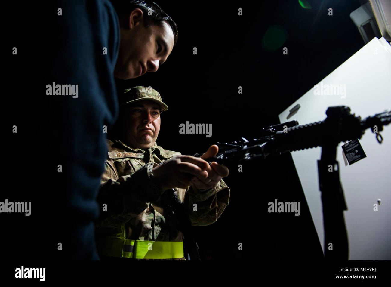 Master Sgt. Burt Traynor, Bravo Flight Chief, 1st Combat Camera Squadron, Joint Base Charleston, South Carolina, clears his weapon before a training mission during Exercise Scorpion Lens 2018, at McCrady Training Center, Eastover, South Carolina, Feb. 12, 2018. Exercise Scorpion Lens is an annual Ability to Survive and Operate training exercise mandated by Air Force Combat Camera job qualification standards. Held at the United States Army Training Center Fort Jackson, S.C., and the McCrady Training Center, Eastover, S.C., the exercise's purpose is to provide refresher training to combat camera Stock Photo