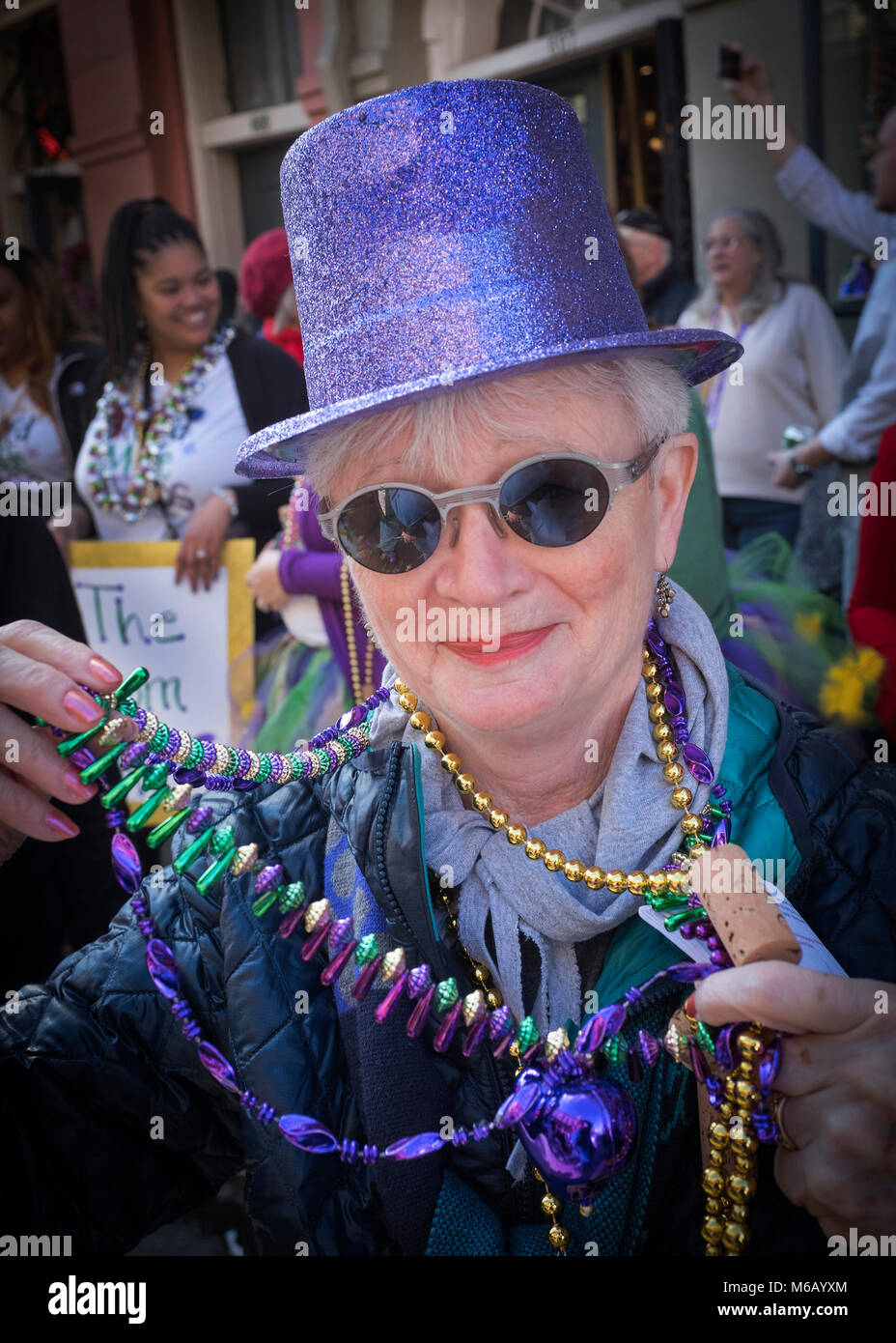 Tourist joining and participating in the Krewe of Cork Mardi Gras Parade, New Orleans, Louisiana, USA Stock Photo