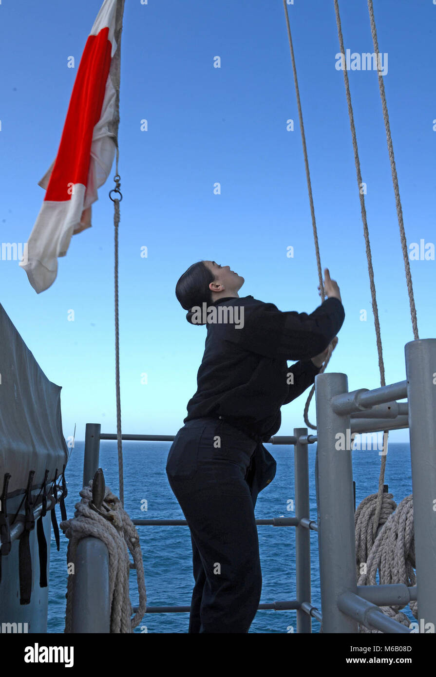 ATLANTIC OCEAN (Feb. 24, 2018) Quartermaster Seaman Vannessa Baltodano raises the foxtrot flag for flight quarters aboard the Wasp-class amphibious assault ship USS Iwo Jima (LHD 7) Feb. 24, 2018. Iwo Jima, homeported in Mayport, Florida, is conducting naval operations in the U.S. 6th Fleet area of operations.  (U.S. Navy Stock Photo