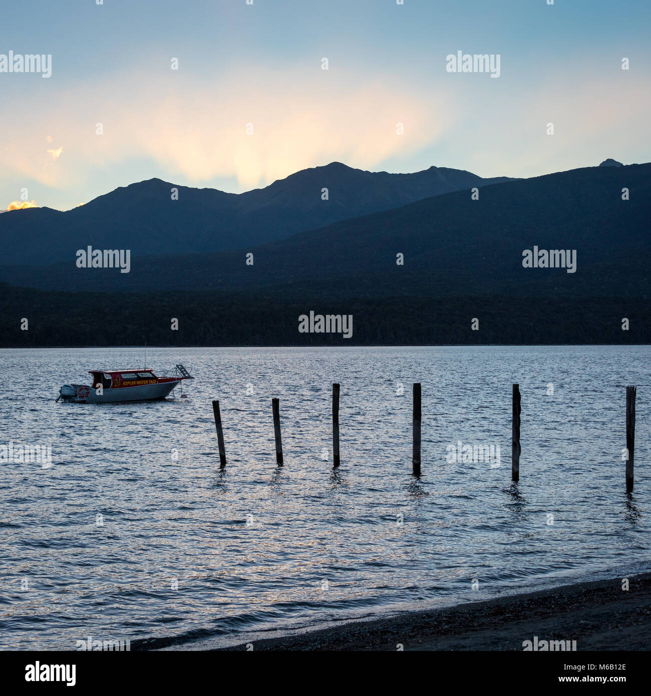 Sunset and Boat at Lake Te Anau, Te Anau, South Island, New Zealand ...