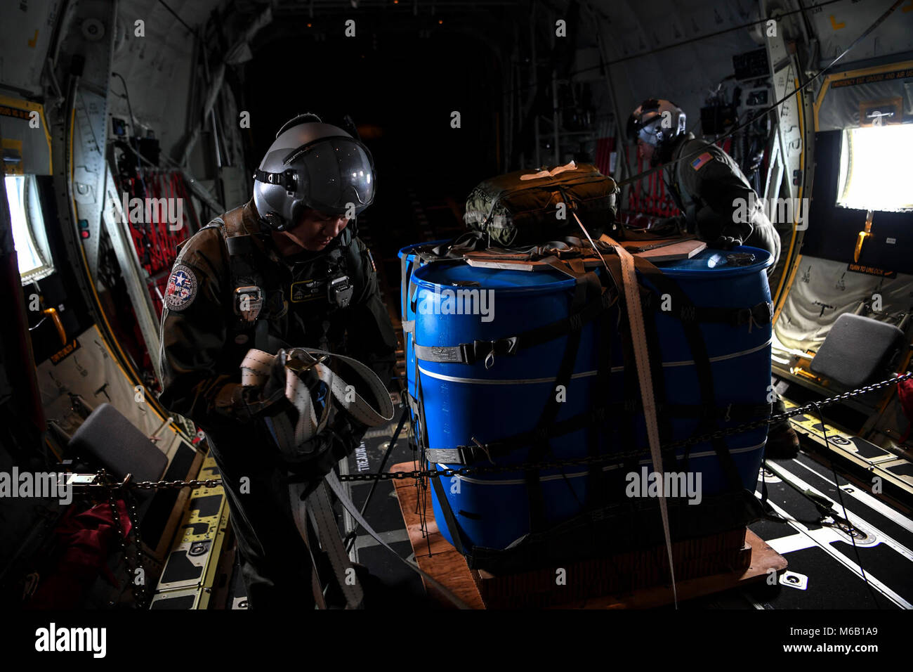 (Left) U.S. Air Force Tech. Sgt. John Quiason and Airman 1st Class Young Achuka, 36th Airlift Squadron loadmasters, prepare a pallet for an airdrop on a U.S. Air Force C-130J Super Hercules during exercise COPE NORTH 18 near Tinian, U.S. Commonwealth of the Northern Mariana Islands, Feb. 27. CN18 is a Pacific Air Forces sponsored tri-lateral field training exercise (FTX) designed to develop synergistic and increase interoperability of U.S. Air Forces, Royal Australian Air Force (RAAF), and the Koku Jieitai (Japanese Air Self-Defense Force). (U.S. Air Force Stock Photo