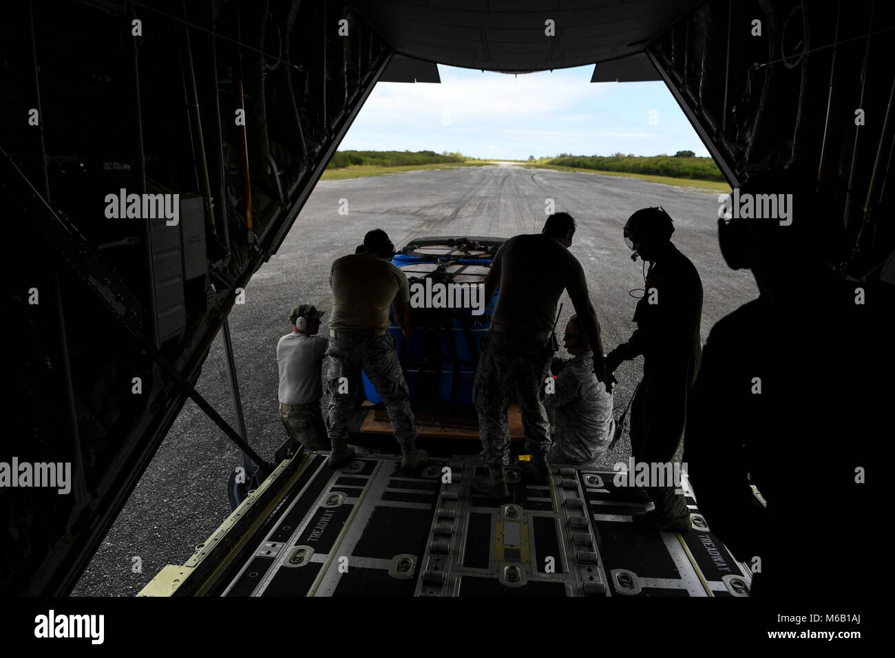 U.S. Air Force maintainers help 36th Airlift Squadron loadmasters recover a pallet back onto a C-130J Super Hercules after an airdrop mission during exercise COPE NORTH 18 at Tinian, U.S. Commonwealth of the Northern Mariana Islands, Feb. 27. CN18 is a Pacific Air Forces sponsored tri-lateral field training exercise (FTX) designed to develop synergistic and increase interoperability of U.S. Air Forces, Royal Australian Air Force (RAAF), and the Koku Jieitai (Japanese Air Self-Defense Force). (U.S. Air Force Stock Photo