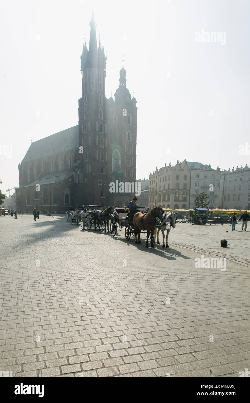 Rynek Glowny (main square),  Mariacki Church (St Mary's Church, Krakow, Poland Stock Photo