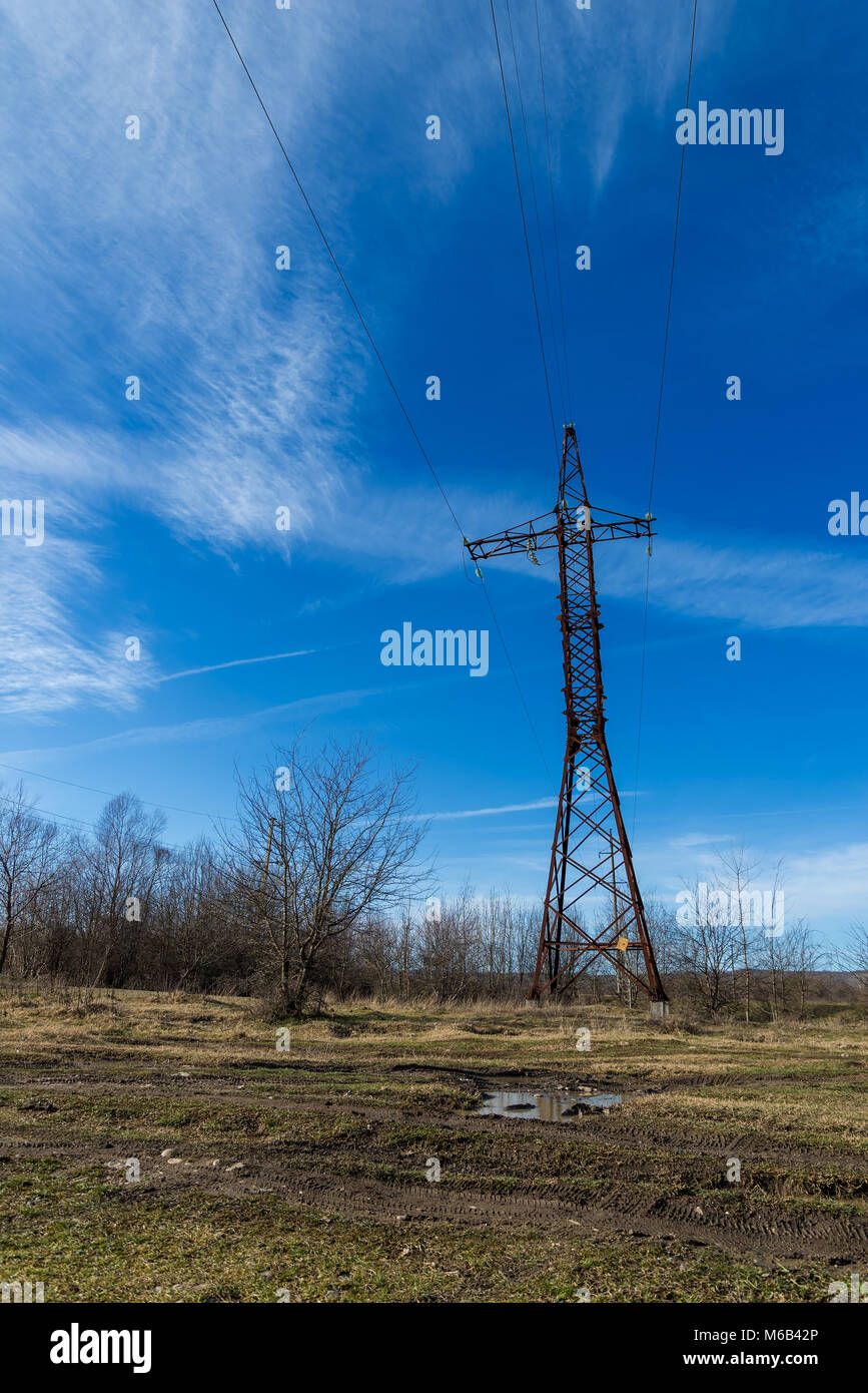 Power line support against blue sky background Stock Photo - Alamy