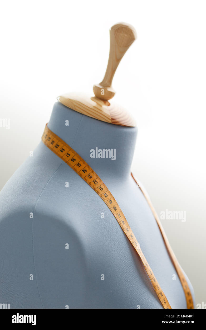 Women's clothing dummy with measuring tape in tailors studio Stock