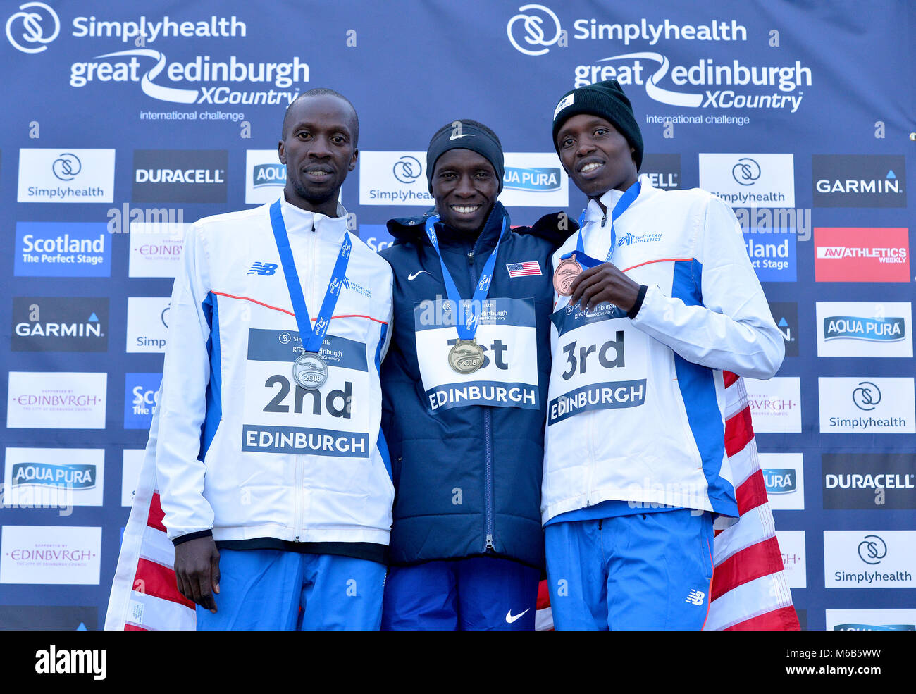 (L-R), EUR Kaan Kigen Ozbilen, USA Leonard Korir and EUR Aras Kaya together at the medal ceremony for the Simplyhealth Great Edinburgh XCountry Men's 8k race during the Great Edinburgh International XCountry 2018 in Holyrood Park, Edinburgh. PRESS ASSOCIATION Photo. Picture date: Saturday January 13, 2018. Photo credit should read: Mark Runnacles/PA Wire. Stock Photo