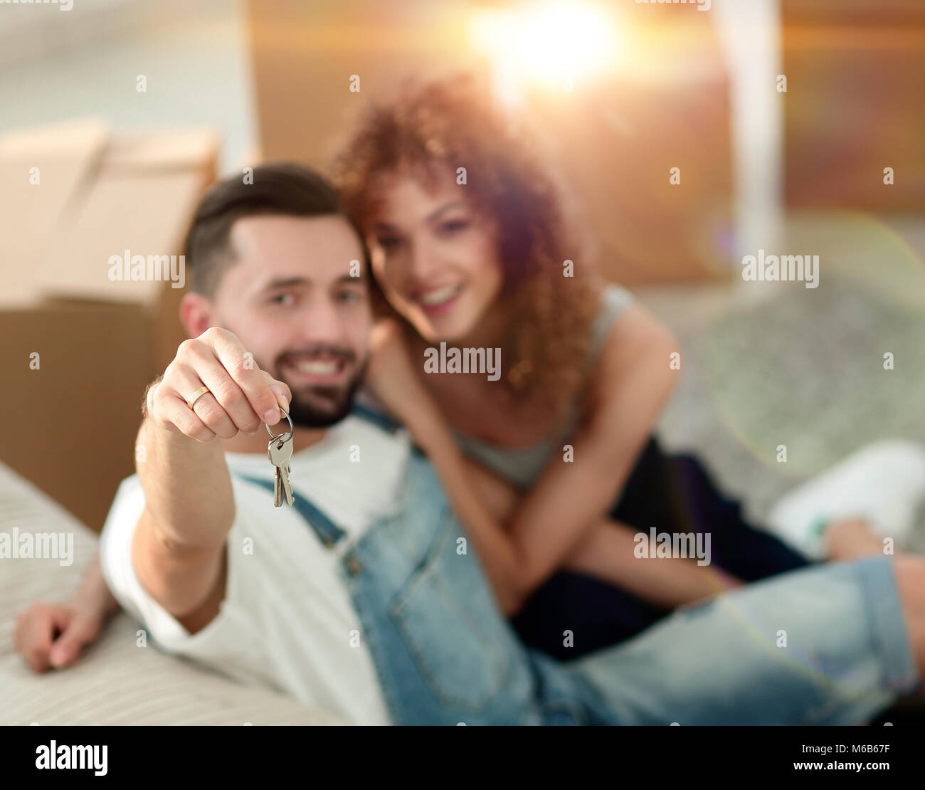 young couple holding the key to a new apartment Stock Photo - Alamy