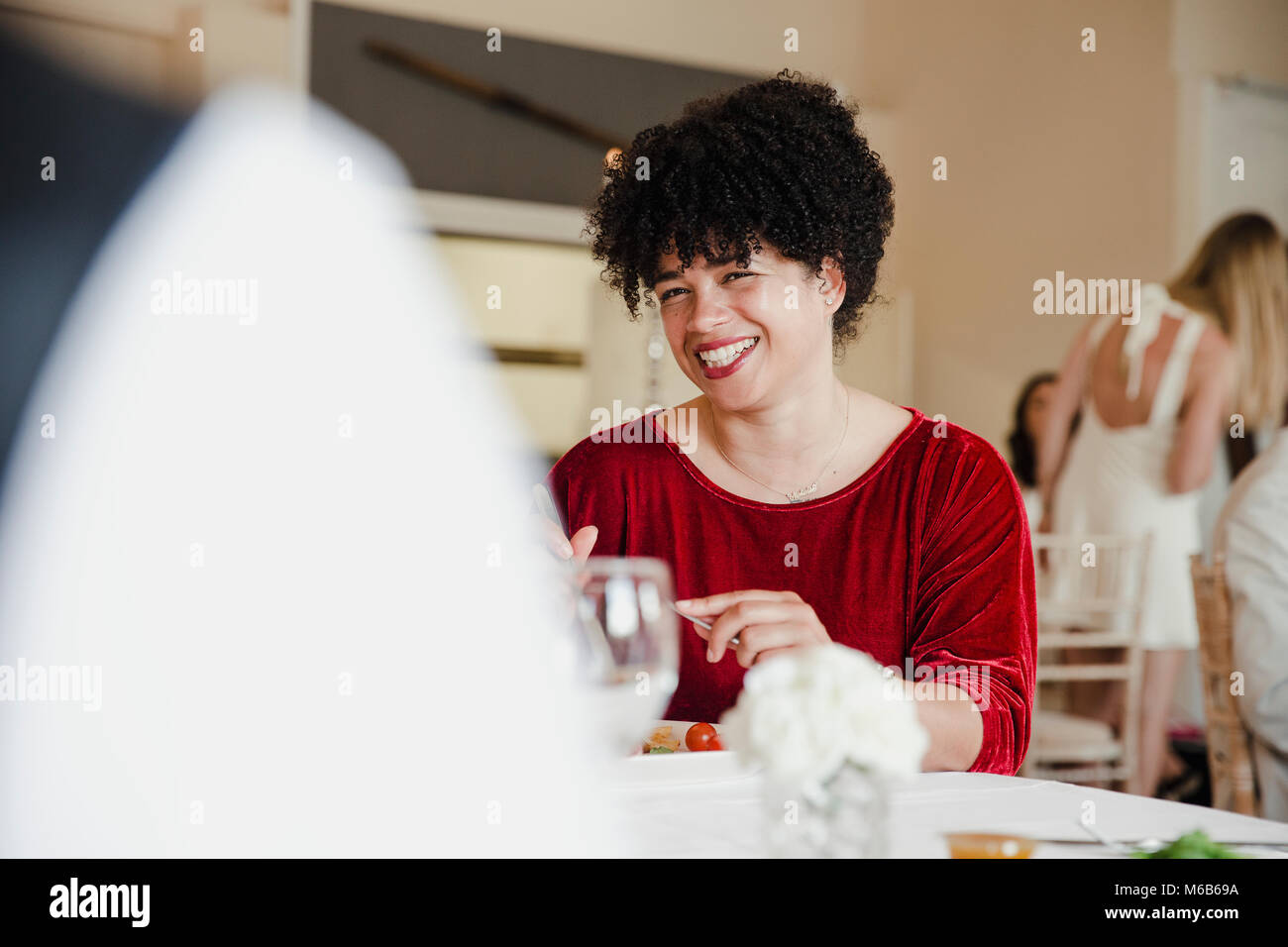 Wedding guests are socialising while enjoying the starter of their meal ...