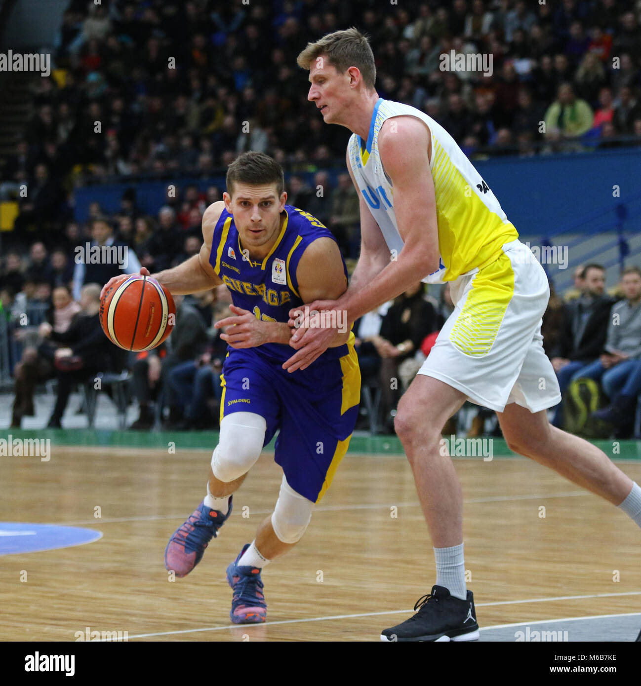 KYIV, UKRAINE - FEBRUARY 26, 2018: Christopher CZERAPOWICZ of Sweden (L) and Artem PUSTOVYI of Ukraine in action during their FIBA World Cup 2019 Euro Stock Photo