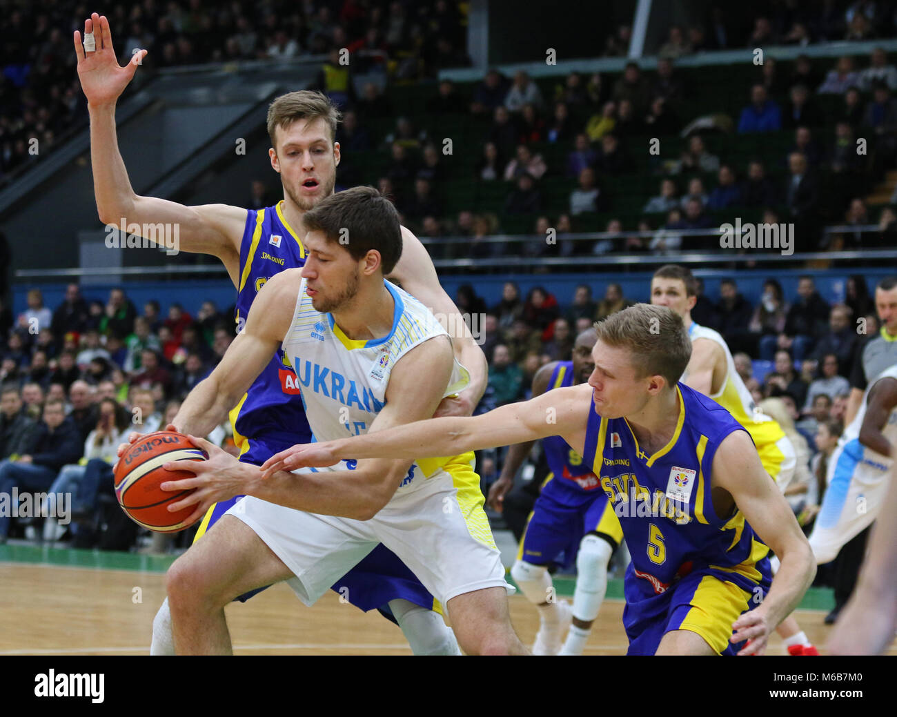 KYIV, UKRAINE - FEBRUARY 26, 2018: Viacheslav KRAVTSOV of Ukraine (in White) fights for a ball with Swedish basketball players during their FIBA World Stock Photo