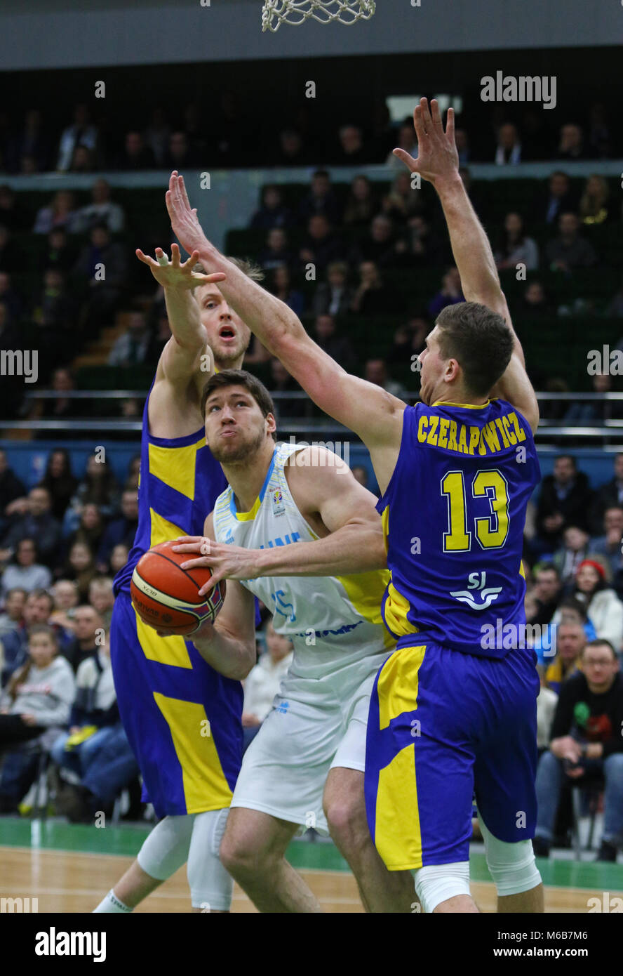 KYIV, UKRAINE - FEBRUARY 26, 2018: Viacheslav KRAVTSOV of Ukraine (in White) fights for a ball with Swedish basketball players during their FIBA World Stock Photo
