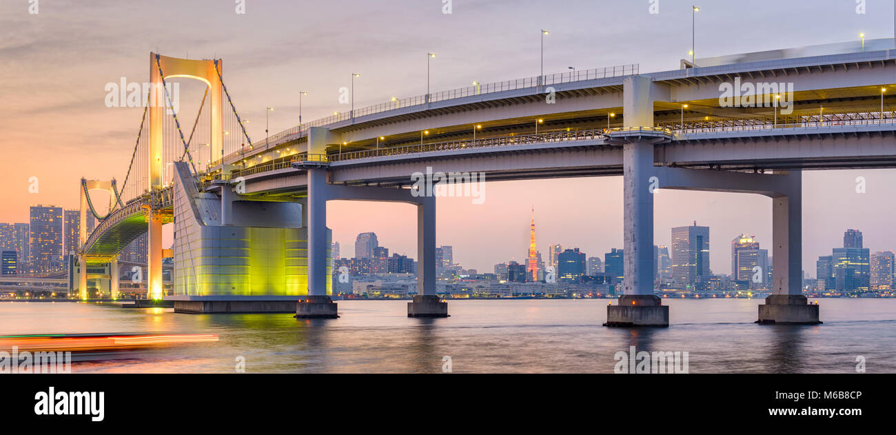 Tokyo, Japan skyline panorama with Rainbow Bridge and Tokyo Tower at dusk. Stock Photo