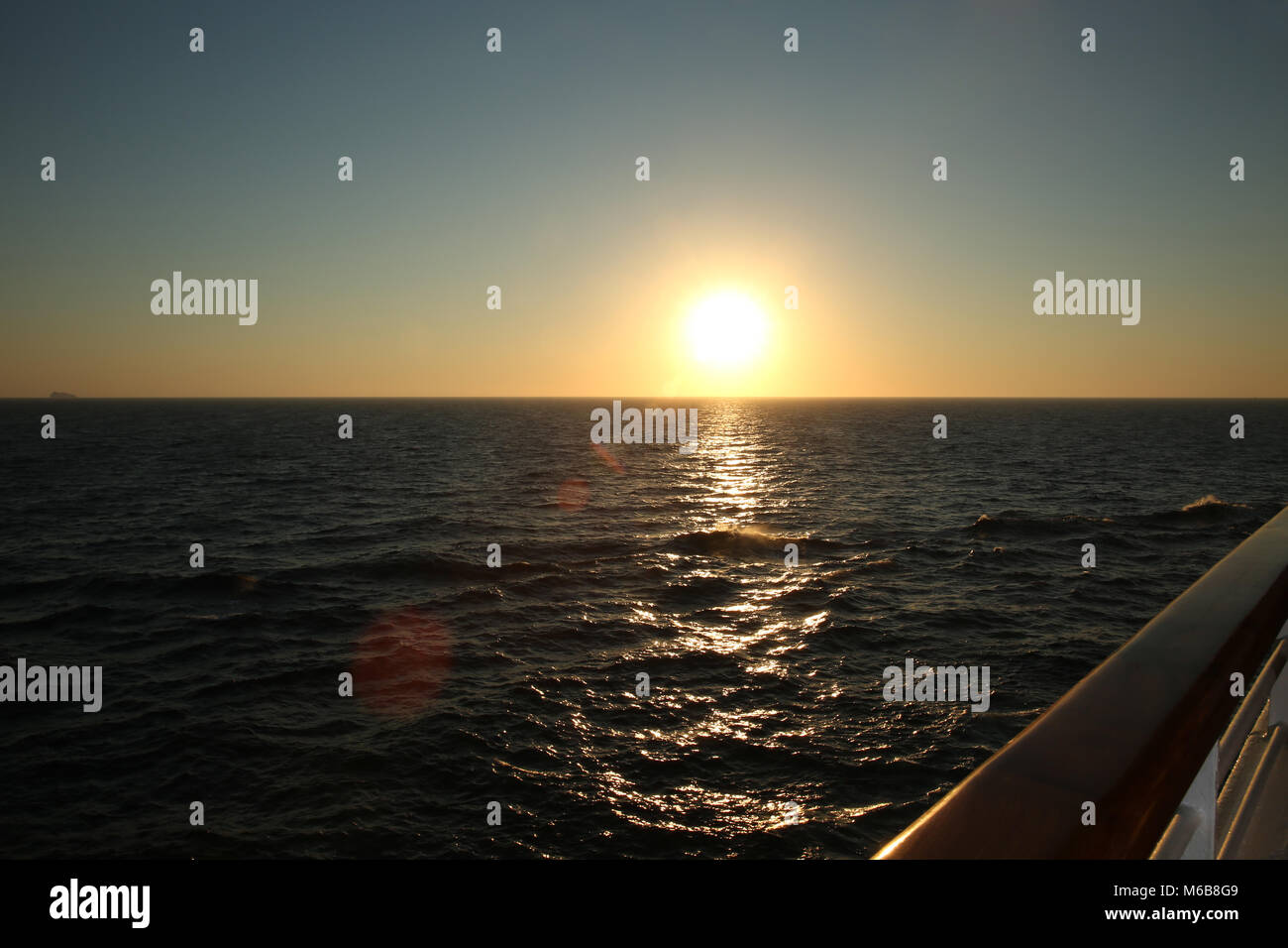 Sunset from the deck of a cruise ship, cruising the Mediteranean Sea. Stock Photo