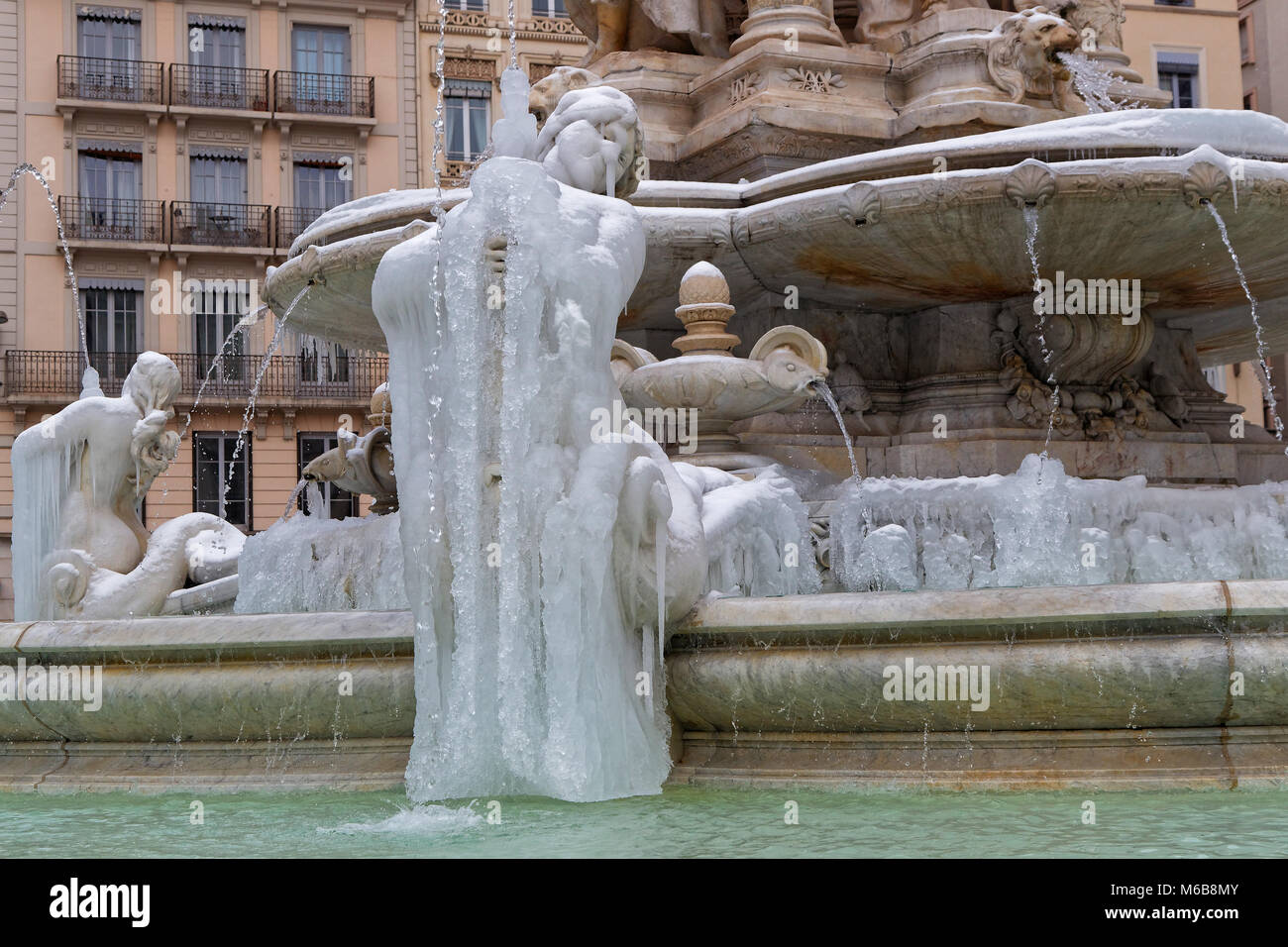LYON, FRANCE, March 1, 2018 : Fountain of Place des Jacobins, as a cold spell rages in all Europe and the Capital of Gallia is under the snow. Stock Photo