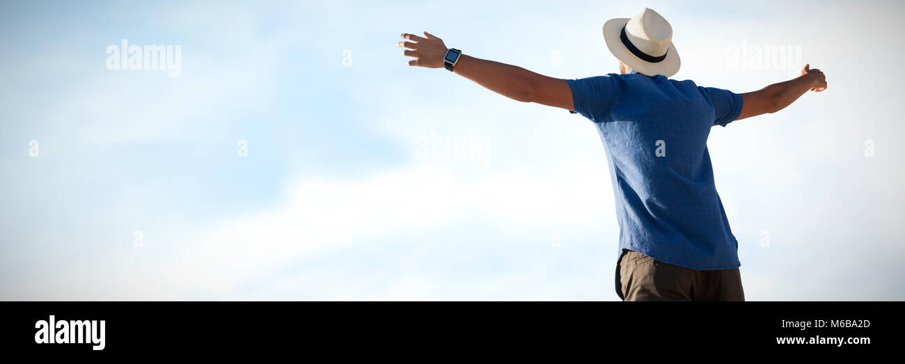Composite image of low angle of a man raising arms up Stock Photo