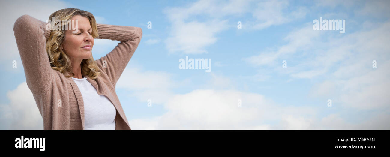Composite image of mature woman stretching with eyes closed Stock Photo