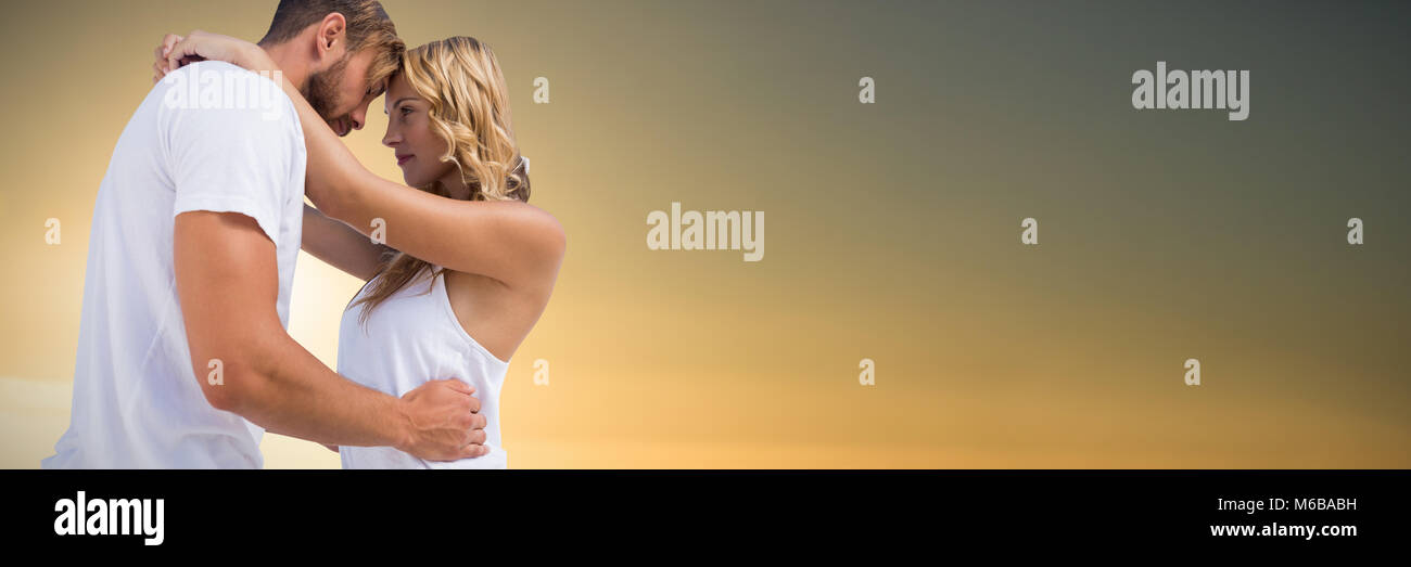 Composite image of couple cuddling against white background Stock Photo