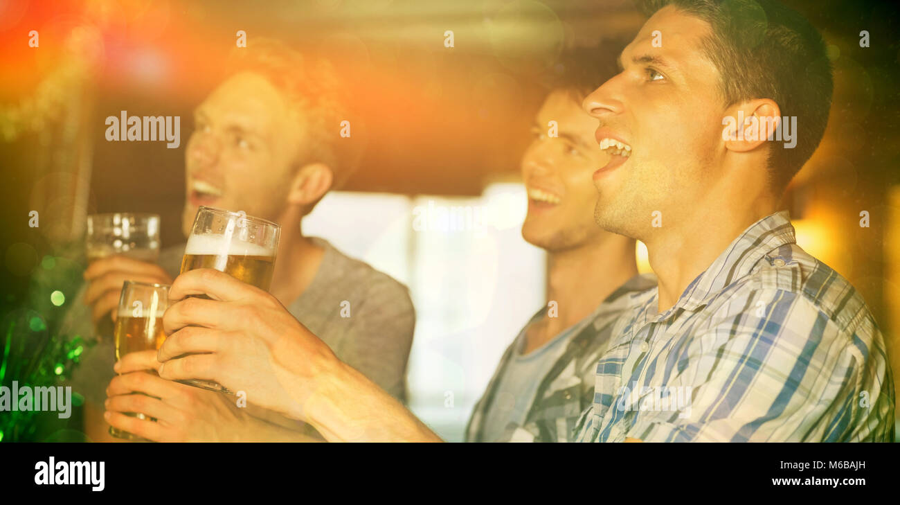 Happy friends toasting with pints of beer on patricks day Stock Photo