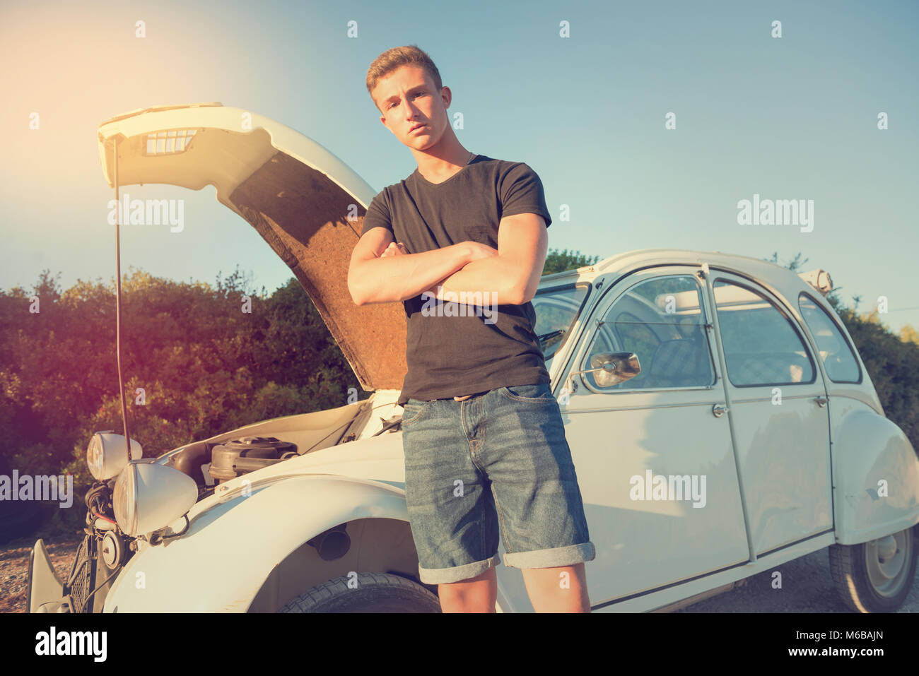 Young men near his broken car waiting for help Stock Photo - Alamy
