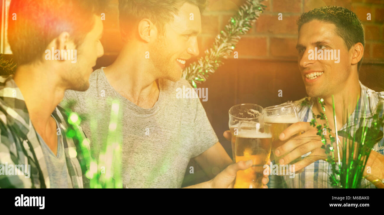 Happy friends toasting with pints of beer on patricks day Stock Photo