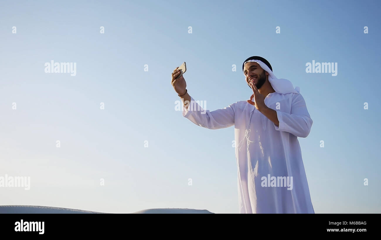Portrait of Arabian sheikh man with gadget that communicates in  Stock Photo