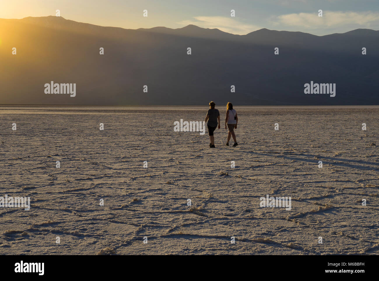 people walking out onto the Badwater salt Flats, Death Valley, California,USA Stock Photo
