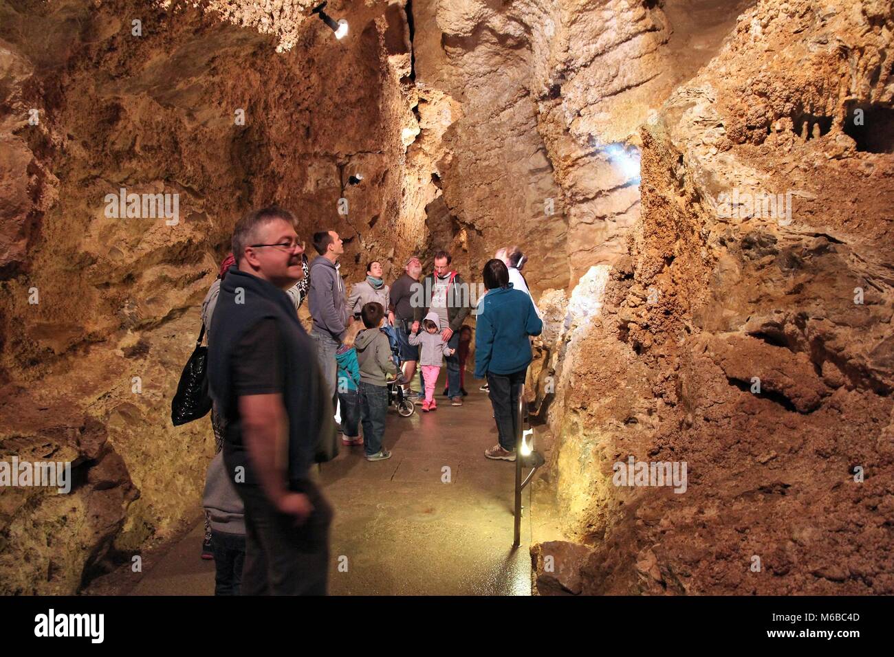BUDAPEST, HUNGARY - JUNE 21, 2014: People visit Palvolgyi Cave in Budapest. Budapest has the largest thermal water cave system in the world. Stock Photo
