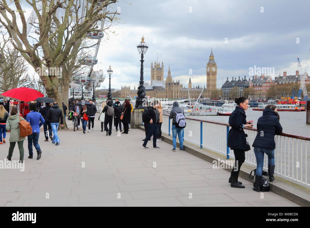 LONDON, UK - APRIL 23, 2016: People visit Thames Embankment in London, UK. London is the most populous city in the UK with 13 million people living in Stock Photo