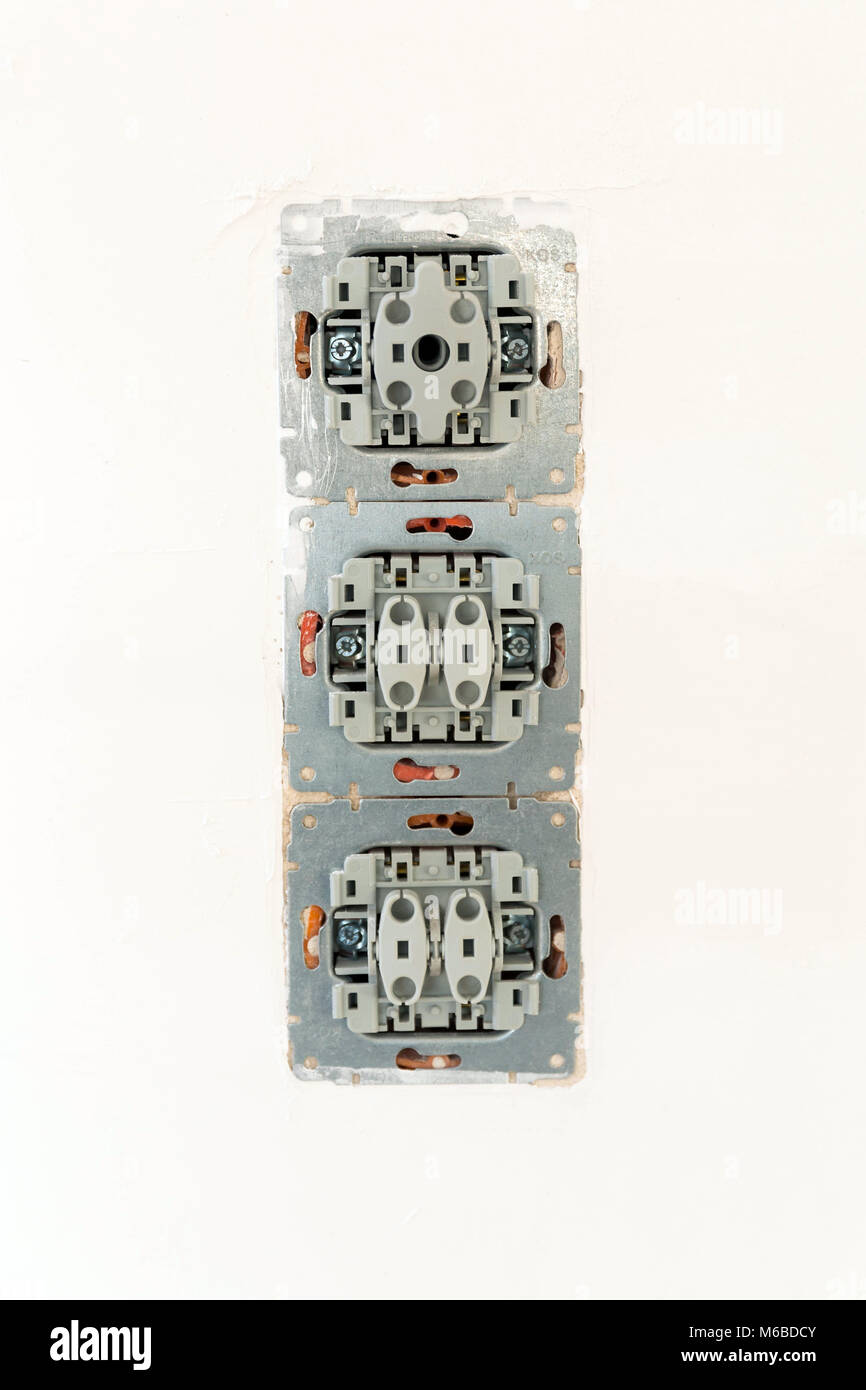 Repairing damaged light switches, installing new Stock Photo Alamy