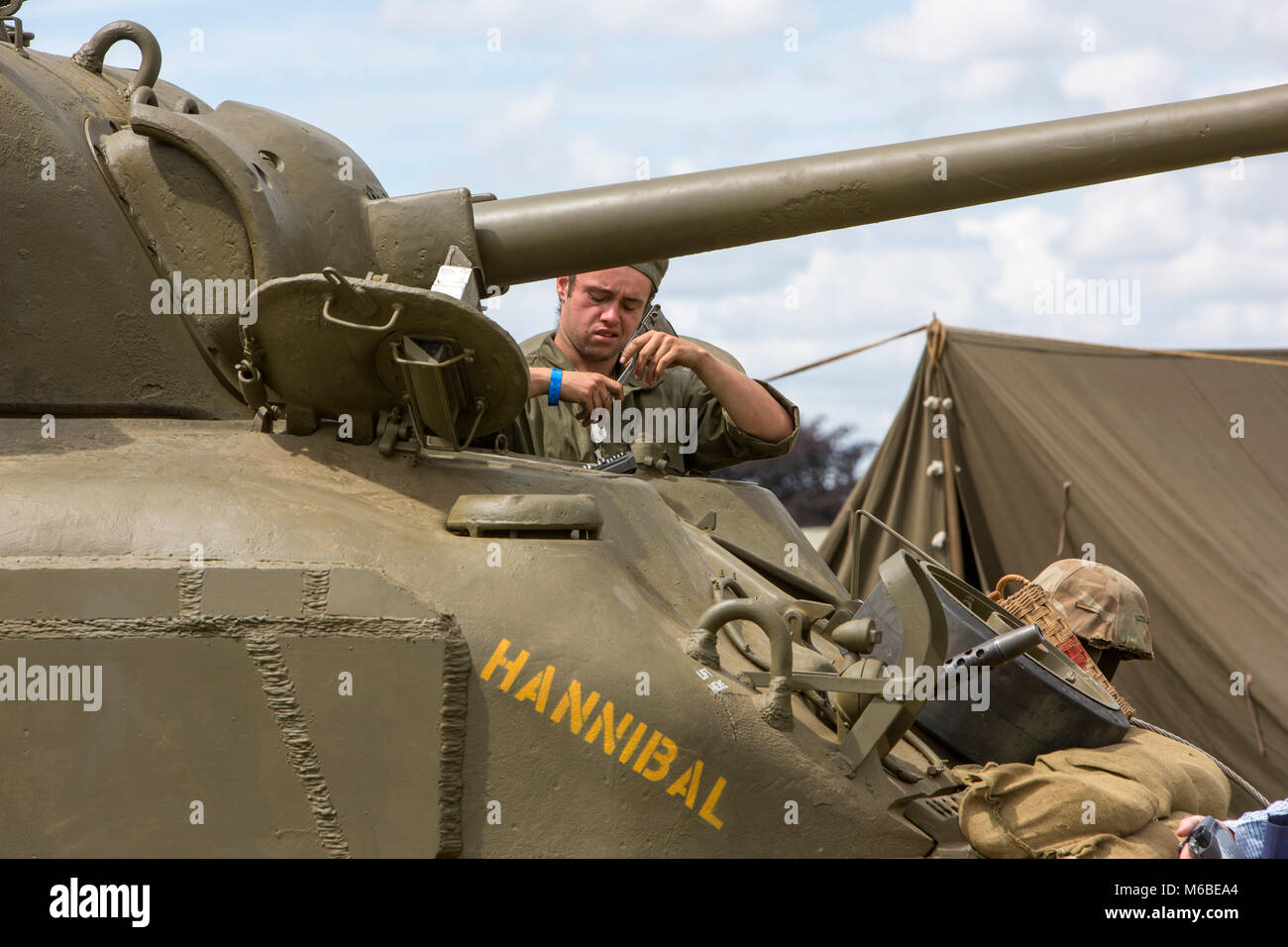 A mechanic working on a tank at a war and peace revival meeting Stock