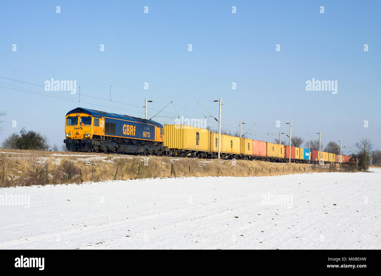 A class 66 diesel locomotive number 66713 working a GBRf intermodal freight near Marks Tey. Stock Photo