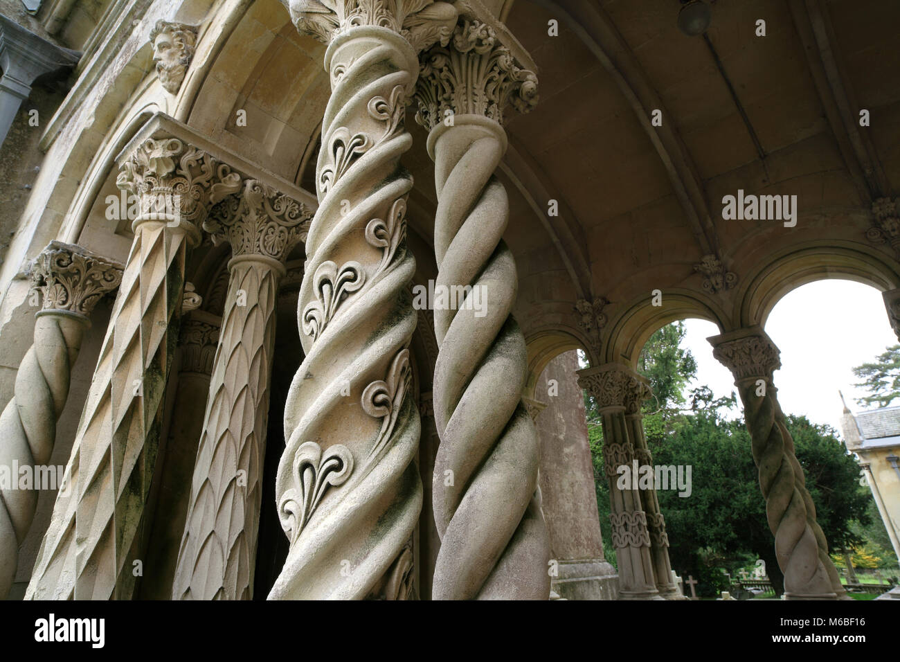 Ornate spiralling columns outside the Church of St Mary and St Nicholas, West Street, Wilton, Hampshire. Stock Photo