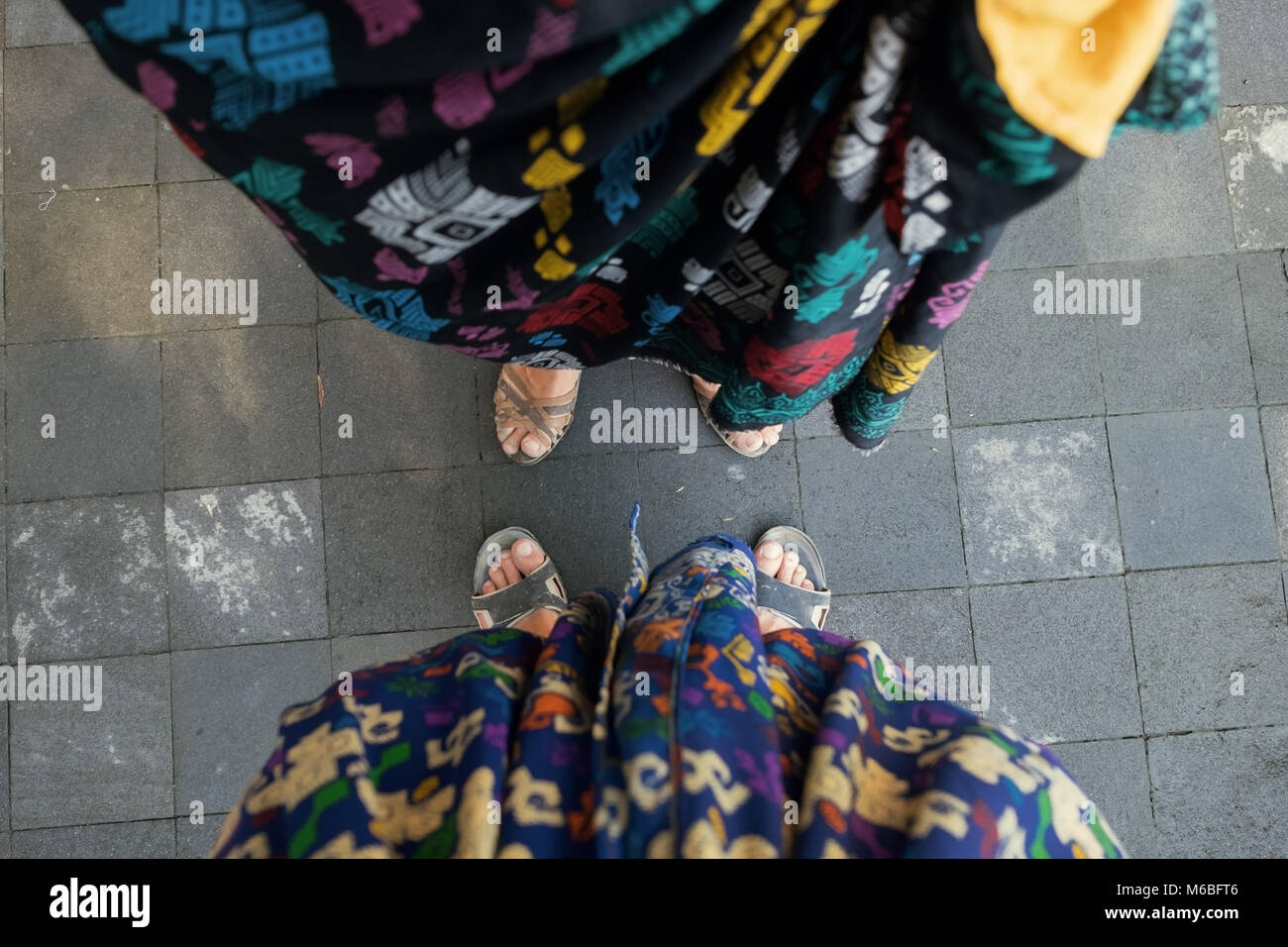 Couple wear traditional clothes in Bali, Indonesia to enter a temple Stock Photo