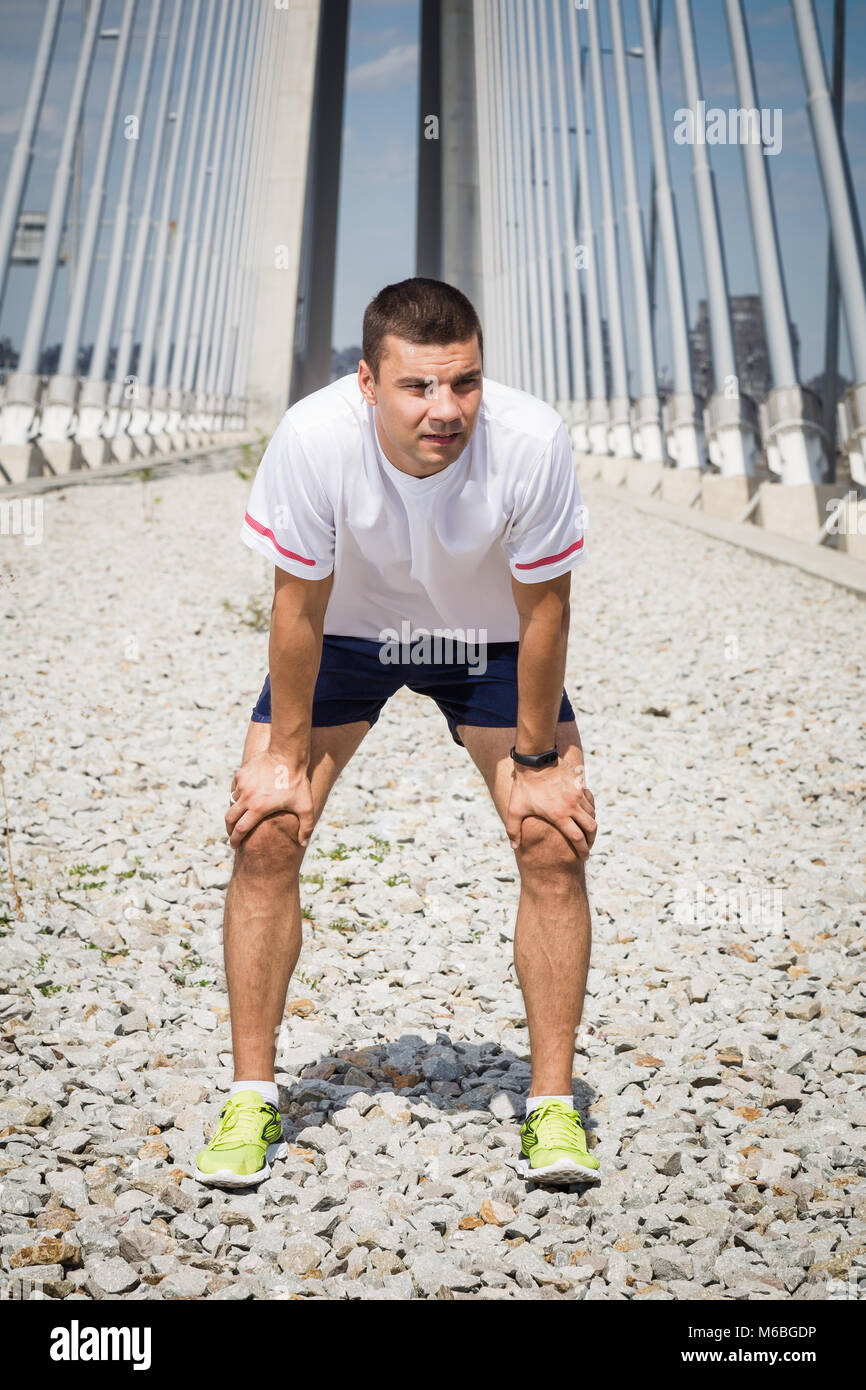 Tired man runner taking a rest after morning exercise Stock Photo Alamy