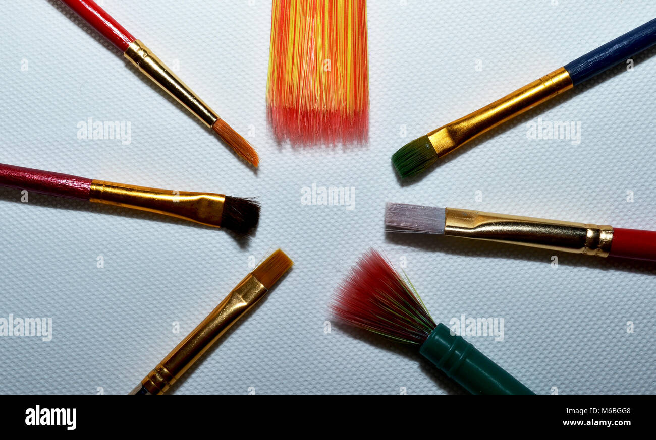 Paint brushes on canvas laid in a circle Stock Photo