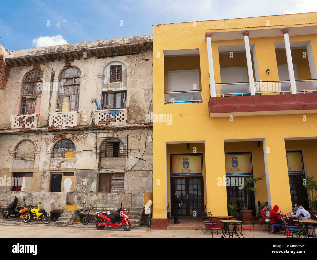 Havana, Cuba - December 11, 2017: Contrast between renovated and decadent buildings on the Malecon of Havana Stock Photo